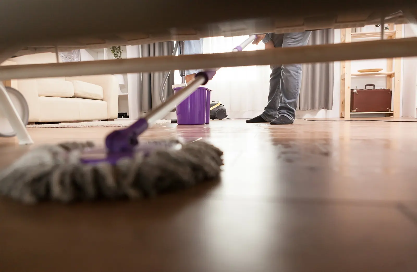 Mopping under a sofa