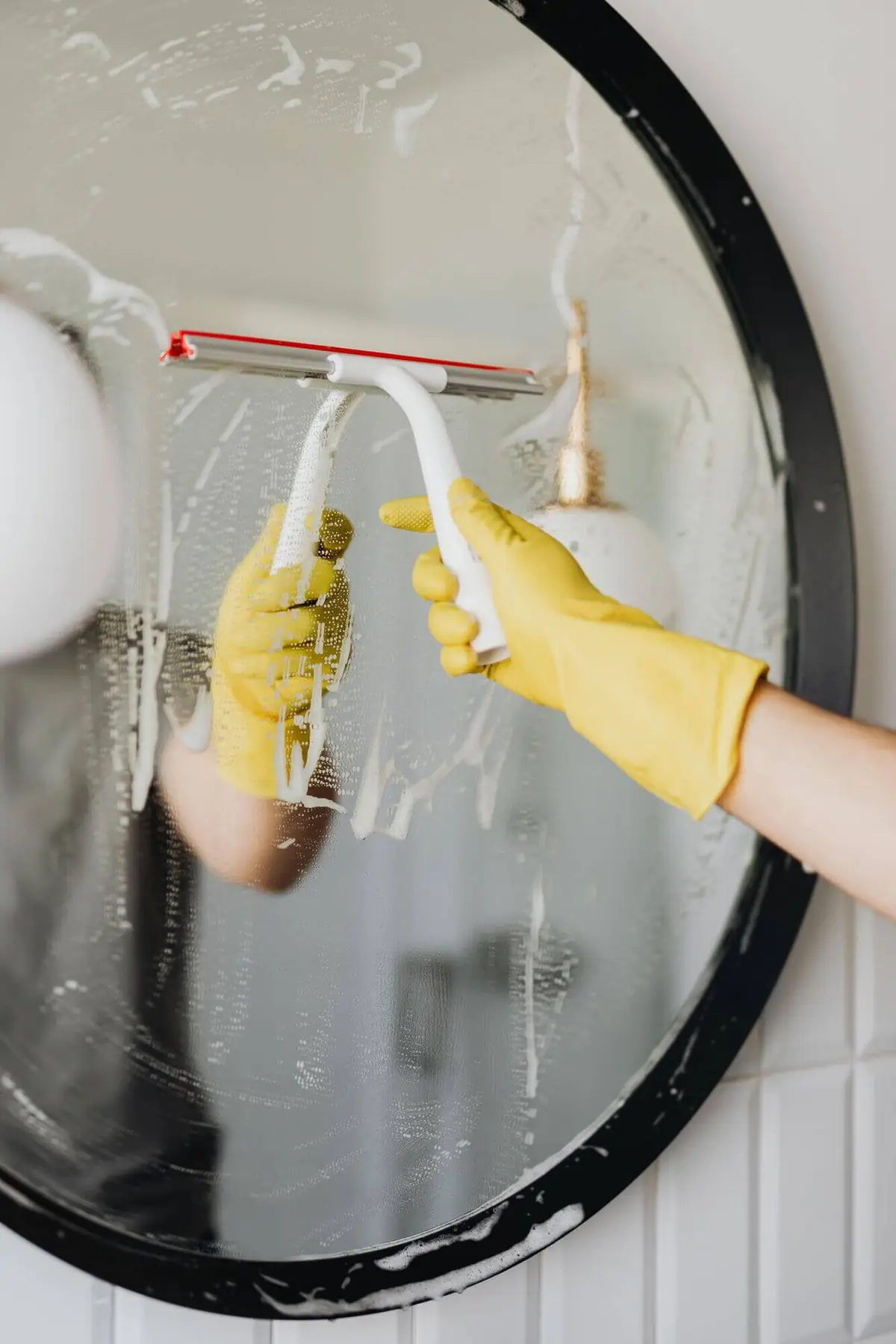 Squeegeeing a round mirror in Delaware, OH